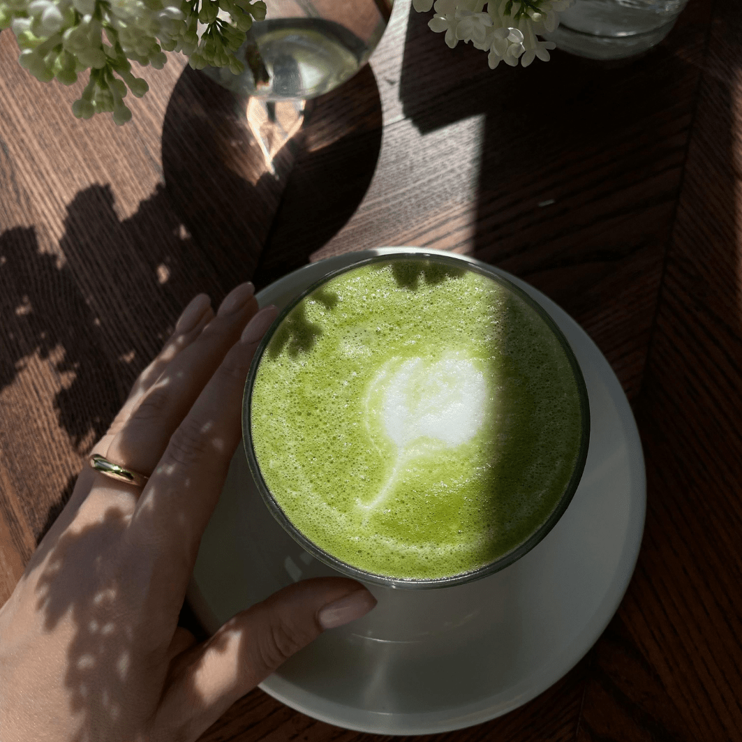 Freshly made cup of Subluna Cool Girl Matcha latte with foam art, captured in natural light, Born Primal Australia