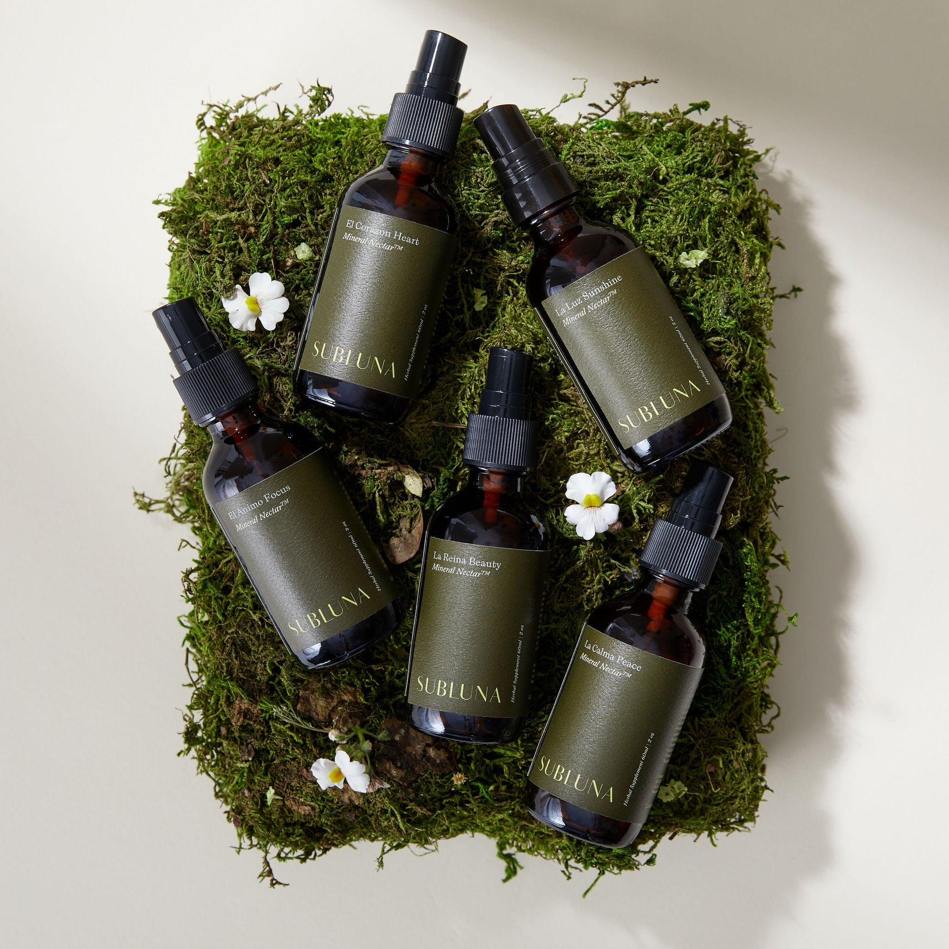 Collection of Subluna Mineral Nectar spray bottles on moss background, natural wellness range now available at Born Primal in Australia